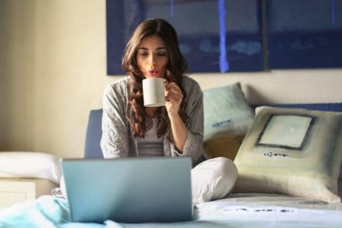 woman in grey jacket working from home